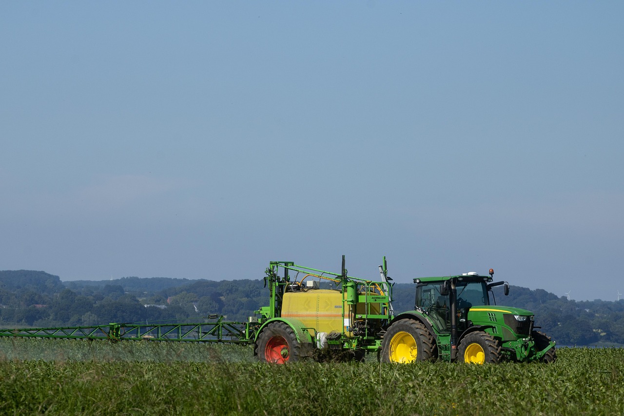 Agricultural sprayer working across a crop field