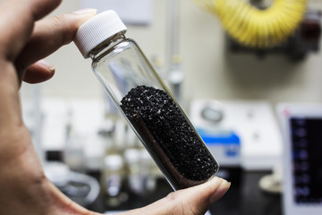 Activated carbon sample inspected in a laboratory setting